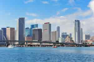 Free photo miami skyscrapers with bridge over sea in the day.