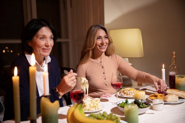 Free Photo middle age friends at night having dinner