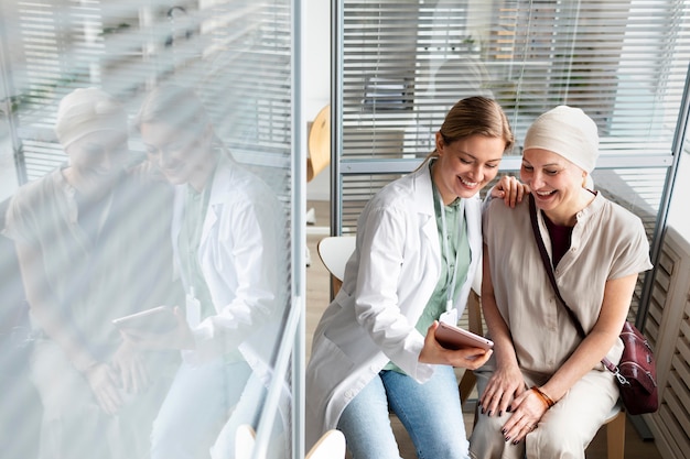 Free Photo middle aged woman with skin cancer talking with her doctor