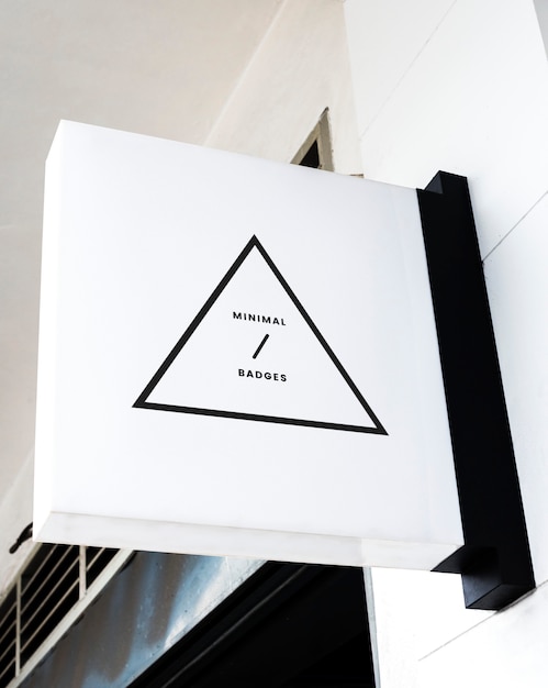 Free photo minimal triangular badge on a white sign mockup