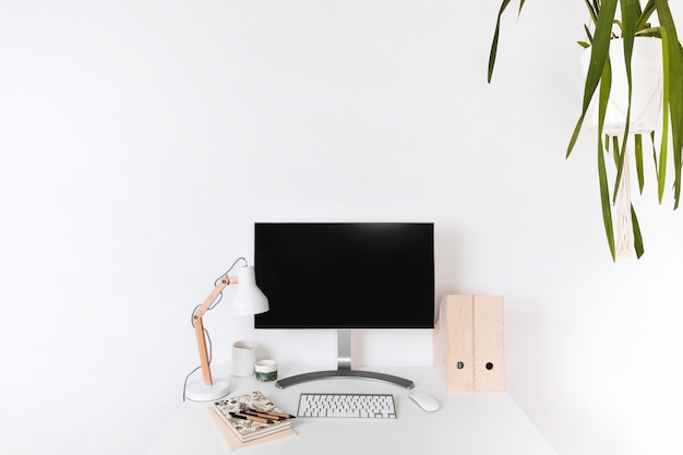 Free Photo minimalistic wooden workplace with blank monitor