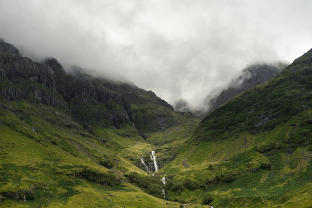 Free Photo mist descending on the mountains of scotland during daytime