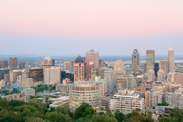 Montreal city skyline at sunset viewed from Mont Royal with urban skyscrapers.