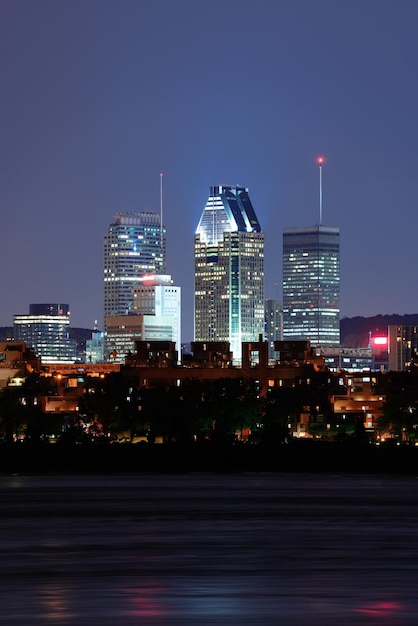 Free photo montreal over river at dusk with city lights and urban buildings