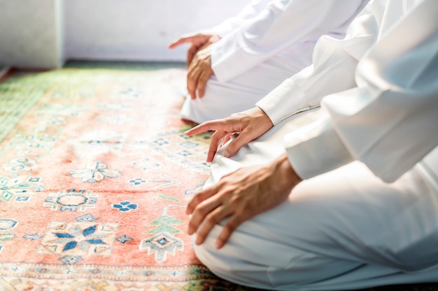 Free photo muslim men praying in tashahhud posture