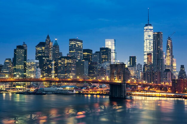 New York City Manhattan midtown at dusk with Brooklyn Bridge. USA.