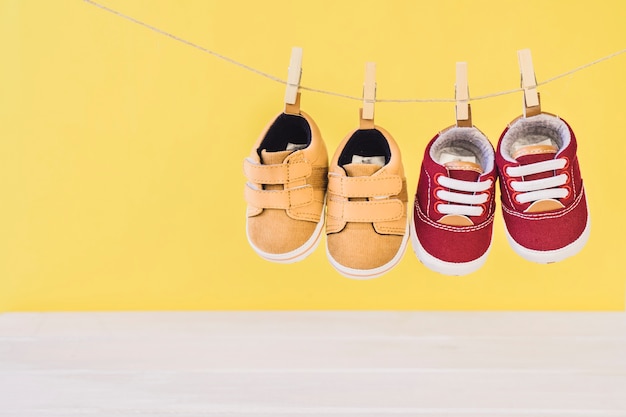 Free photo newborn concept with two shoes on clothesline