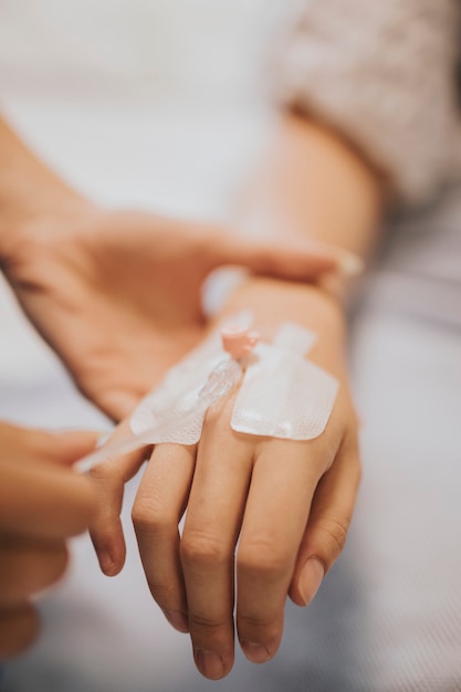 Free photo nurse applying an iv drip to a patient