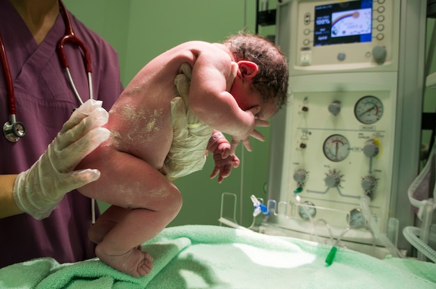 Free photo nurse holding newborn baby