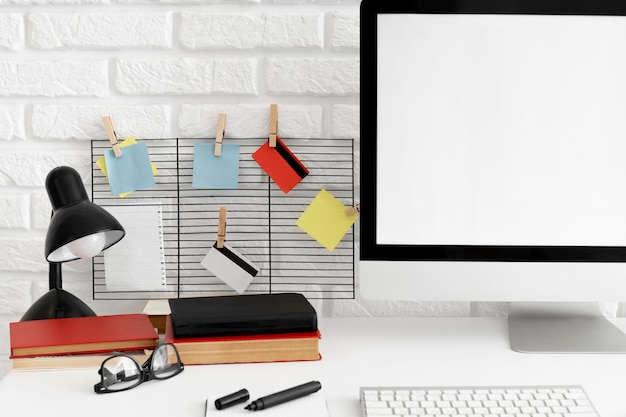 Free Photo office desk with computer screen and lamp