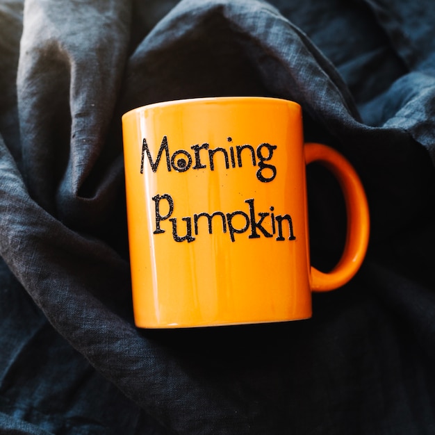 Free Photo orange mug with writing