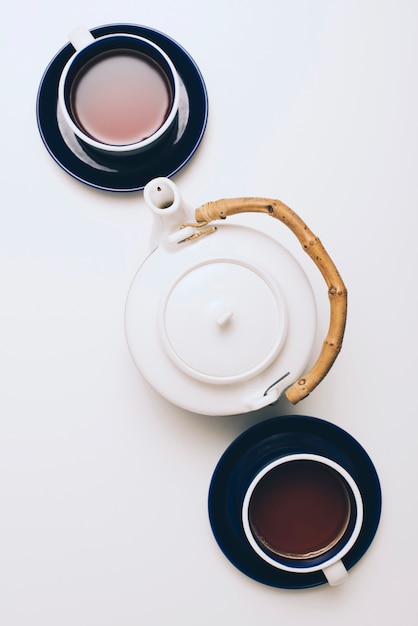 An overhead view of coffee cup and teapot isolated on white background