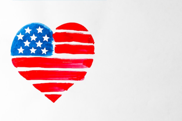 Free photo painted red and blue heart shape united states american flag on white background