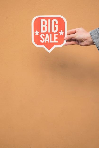 Free photo person holding red sign