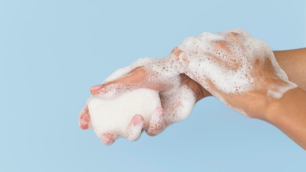 Person washing hands with soap