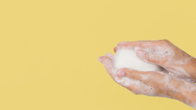 Person washing hands with soap