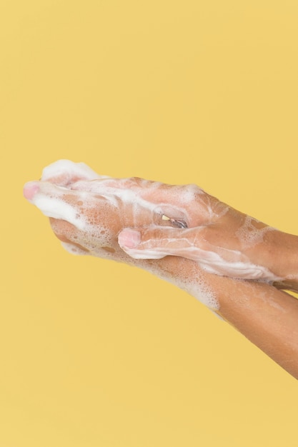 Person washing hands with soap