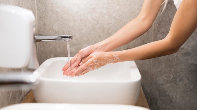 Free photo person washing hands with soap