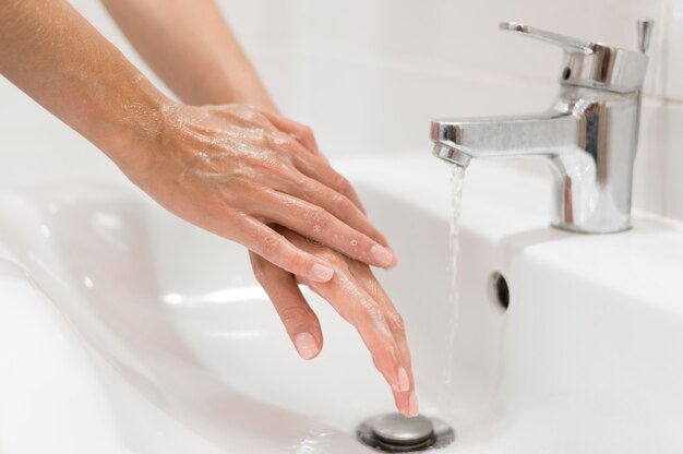 Person washing hands with soap