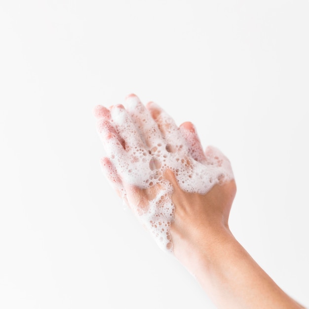 Person washing hands with soap