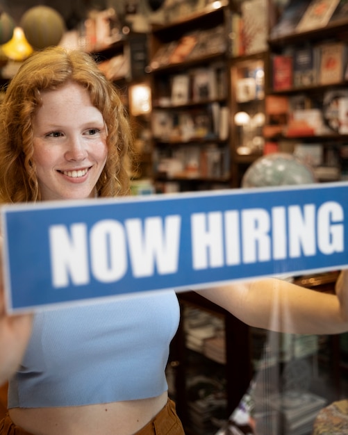 Free Photo person with hiring sign by the window