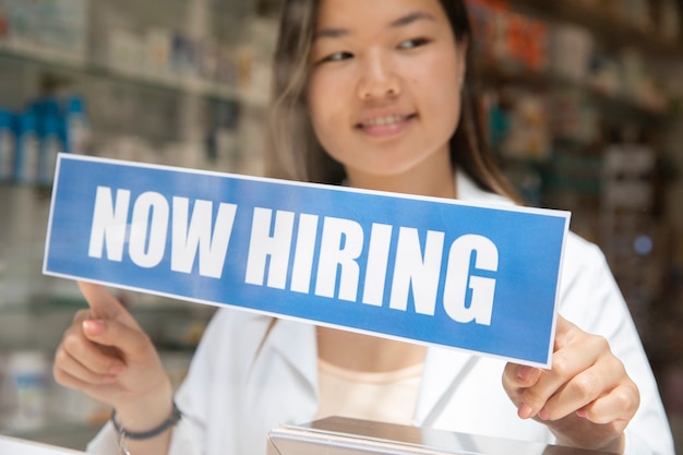 Free Photo person with hiring sign by the window