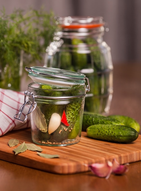 Free Photo pickles with garlic in glass jar on cutting board