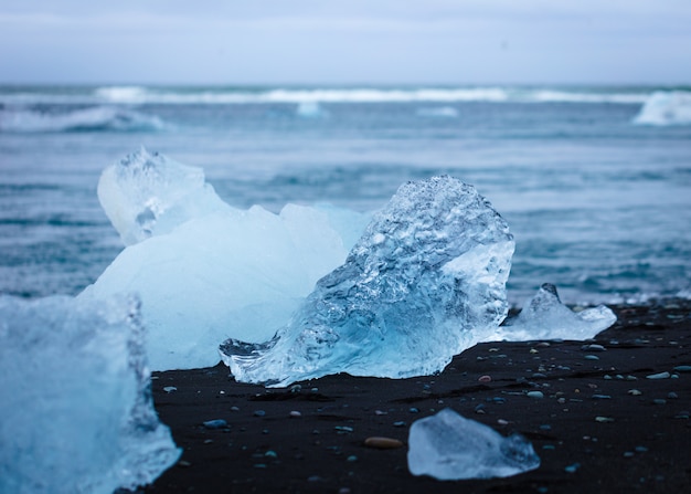 Free photo a piece of ice on the beach