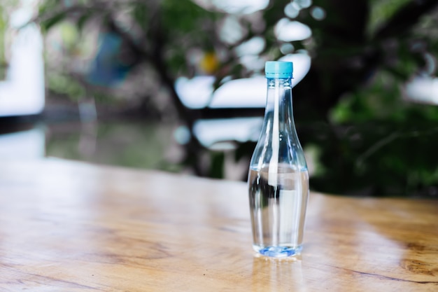 Plastic bottle of water on wooden table