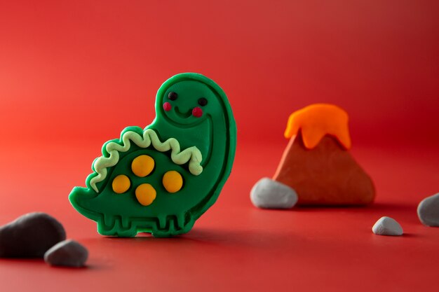 Playdough art with dinosaur and vulcano