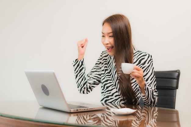 Free Photo portrait beautiful young asian woman use computer laptop on working table in room