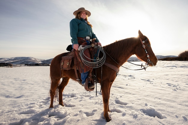 Free photo portrait of cowgirl on a horse