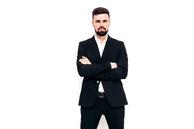 Free photo portrait of handsome confident stylish hipster lambersexual model sexy modern man dressed in elegant black suit fashion male posing in studio near white wall isolated