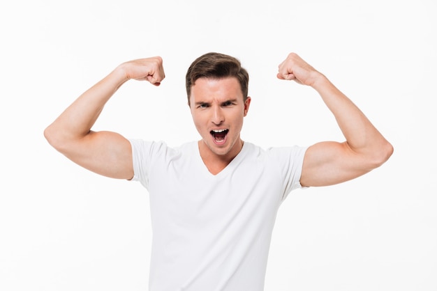 Free Photo portrait of a handsome strong man flexing his biceps