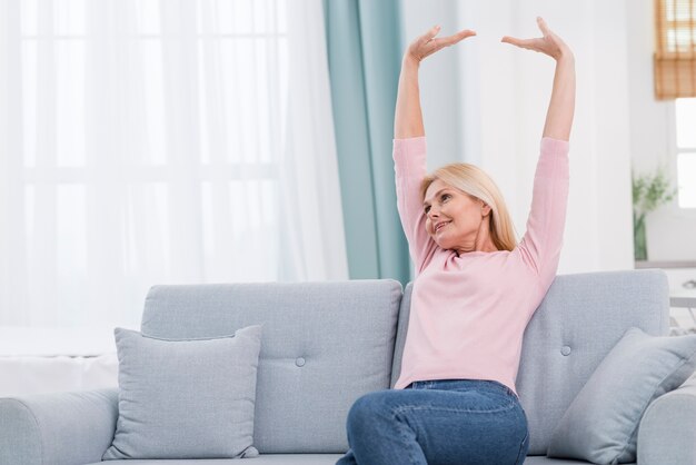 Portrait of lovely mature woman stretching