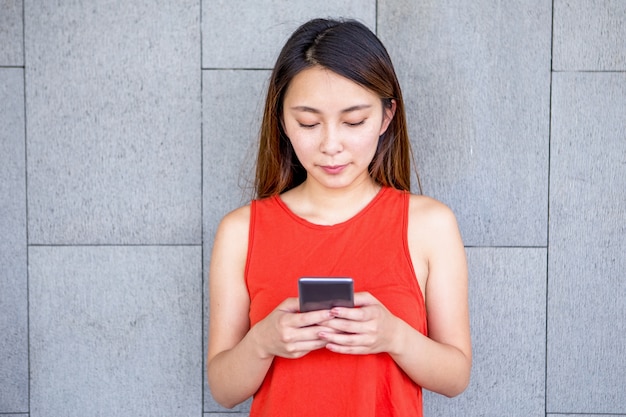 Free photo portrait of serious asian girl using mobile phone