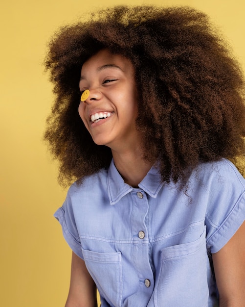 Free Photo portrait of young adorable girl posing with emoji stickers on her face