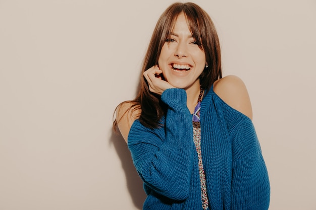 Free Photo portrait of young beautiful smiling hipster girl in trendy summer clothes. sexy carefree woman posing near wall in studio. positive model having fun