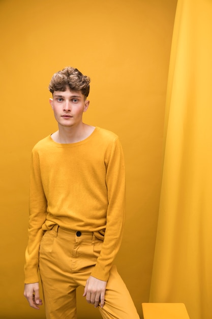 Free photo portrait of a young man in a yellow scene