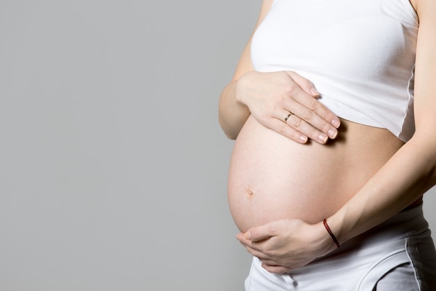 Free photo pregnant woman  touching her belly