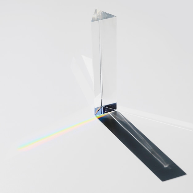 Free Photo a prism dispersing sunlight splitting into a spectrum on a white background