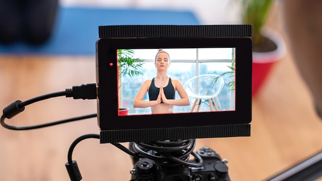 Free Photo professional cameraman with camera and external display recording a young blonde woman