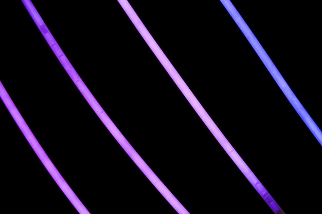 Free photo purple neon stripes on black background