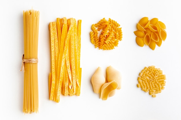 Free photo raw assortment of pasta on white background