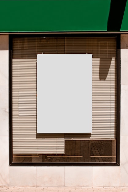 Free Photo rectangular blank billboard on glass window with blinds