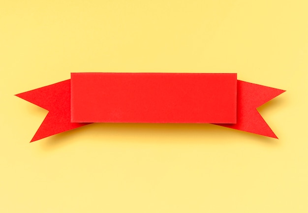 Free photo red ribbon on yellow background