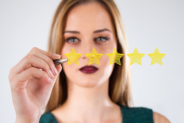 Free Photo review, increase rating or ranking, evaluation and classification concept. businessman draw five yellow star to increase rating of his company