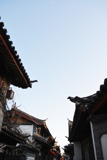 Free photo roofs of houses with sky background