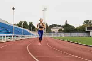 Free photo runner woman training at stadium