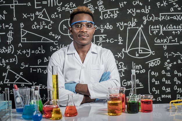 Scientists wear glasses and folded arms in the laboratory